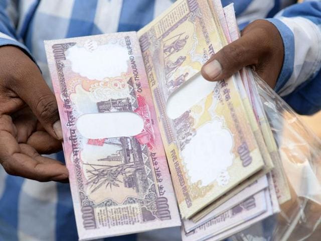 A vendor displays wallets made from replica prints of the demonetised Rs 500 and Rs 1000 notes for sale at a stall in Mumbai. (AFP File Photo) A vendor displays wallets made from replica prints of the demonetised Rs 500 and Rs 1000 notes for sale at a stall in Mumbai. (AFP File Photo)