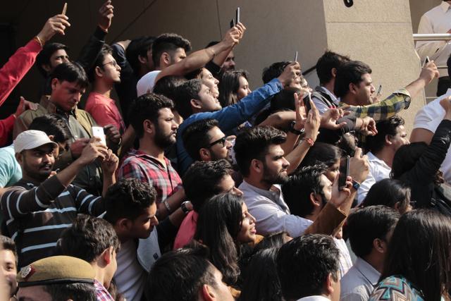 The student in the crowd cheer and click pictures as Bollywood actors Ranveer Singh and Vani Kapoor dance on the stage. (Shivam Saxena/HT Photo)