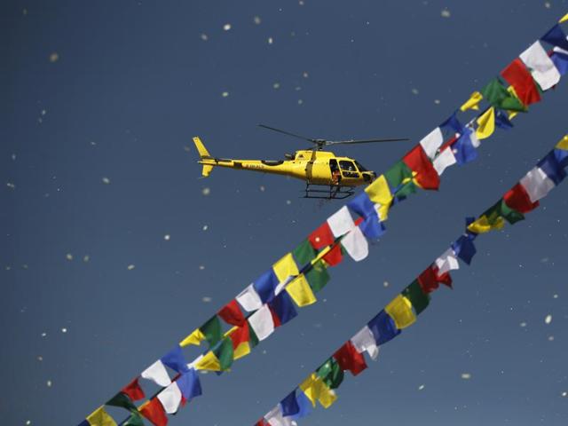 Flowers are showered from a helicopter during the final day of the purification ceremony. Boudhanath and Swayambhunath are the two most popular tourist destinations in Nepal. (AP) 