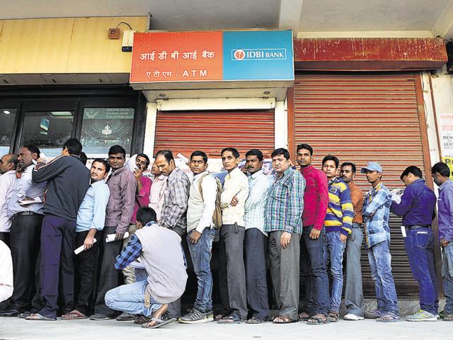 Customers queue up outside a bank in Sector 10A on Tuesday. (Parveen Kumar/HT Photo) Customers queue up outside a bank in Sector 10A on Tuesday. (Parveen Kumar/HT Photo)