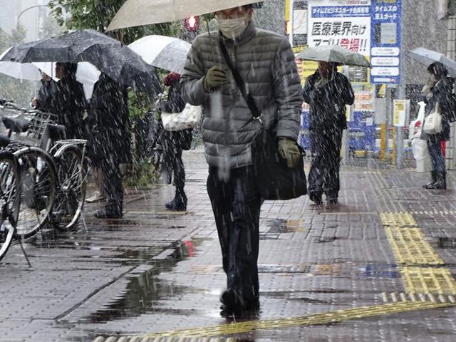 A man stands near the gate in the snow at Kanda Myojin shrine in Tokyo, Thursday.Tokyo residents have woken up to the first November snowfall in more than 50 years. (AP Photo) A man stands near the gate in the snow at Kanda Myojin shrine in Tokyo, Thursday.Tokyo residents have woken up to the first November snowfall in more than 50 years. (AP Photo)