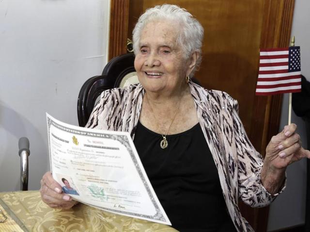 America Maria Hernandez holds an American flag after being administered the Naturalization Oath of Allegiance, in the Queens borough of New York. (AP Photo) America Maria Hernandez holds an American flag after being administered the Naturalization Oath of Allegiance, in the Queens borough of New York. (AP Photo)