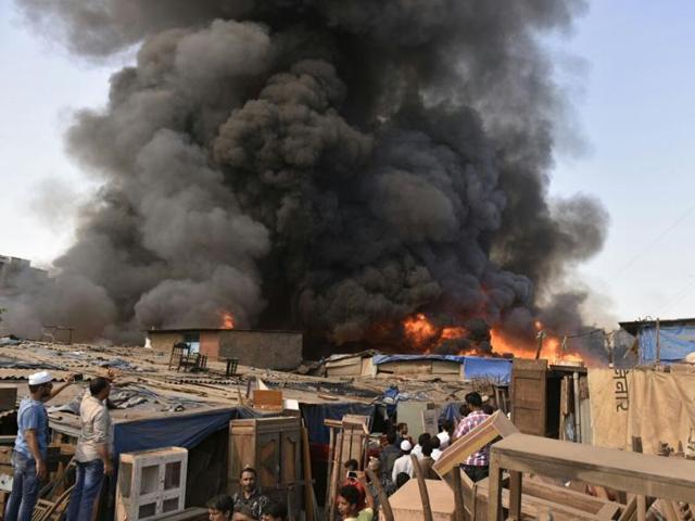 The fire brigade is working to bring the blaze that broke out at Oshiwara under control.(Samson Tupdal/HT Photo)