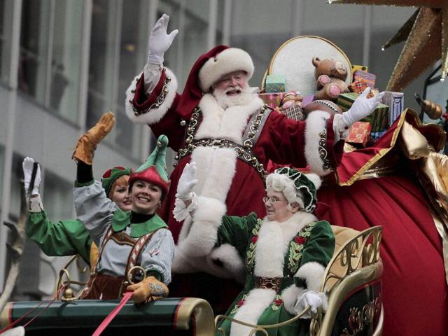 Santa Claus waves from his float as he passes by a street full of spectators. (AP) Santa Claus waves from his float as he passes by a street full of spectators. (AP)