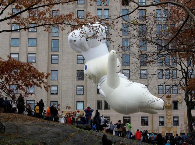 People watch from Central Park as the Pillsbury Doughboy makes it's way down West 59th Street. (REUTERS) People watch from Central Park as the Pillsbury Doughboy makes it's way down West 59th Street. (REUTERS)