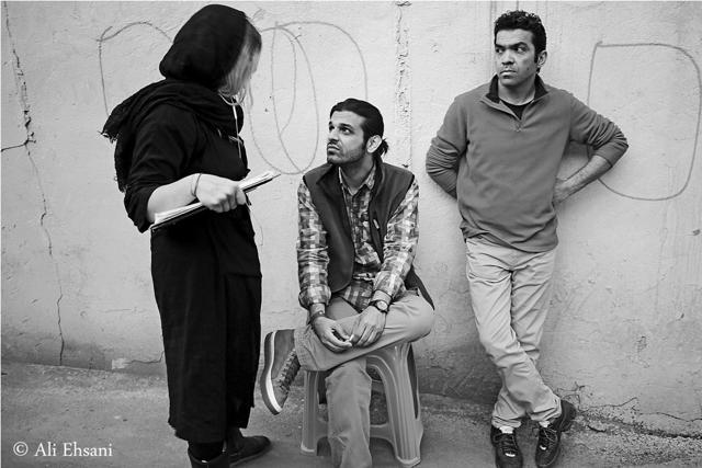 In this undated photo provided by Iranian filmmaker Keywan Karimi, Karimi, middle, speaks with his script supervisor during a scene of the movie called Drum, Tehran, Iran. Iranian filmmaker Keywan Karimi's production company says he has begun serving a year-long jail sentence handed down over footage deemed insulting by authorities. (AP)