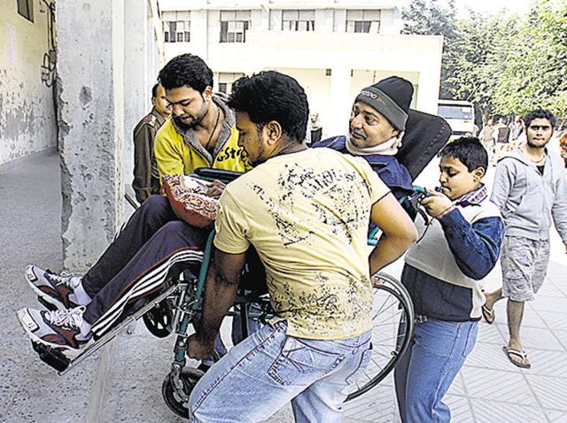 A disabled man is helped to enter a building without ramps. Plans to make 50 government buildings disabled friendly are gathering dust. A disabled man is helped to enter a building without ramps. Plans to make 50 government buildings disabled friendly are gathering dust.