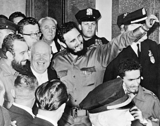 In this Sept. 20, 1960 file photo, Fidel Castro holds a cigar as he stands with Soviet Premier Nikita Khrushchev outside Hotel Theresa in Harlem, New York. (AP)