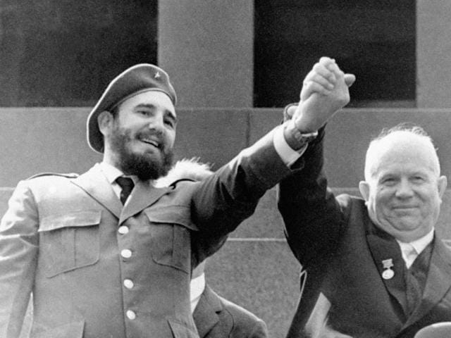 In this May 1, 1963 file photo, Cuba's leader Fidel Castro, left, and Soviet Premier Nikita Khrushchev clasp hands at the Lenin mausoleum in Moscow's Red Square on May Day in Moscow, Russia. (AP) 