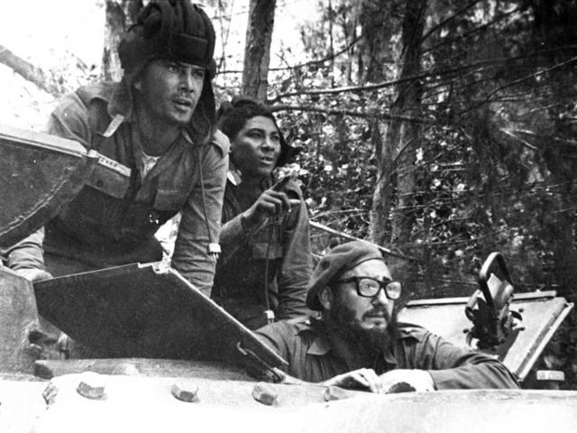 In this April 1961 file photo, Cuba's leader Fidel Castro, bottom, looks out from a tank during the Bay of Pigs invasion in Cuba.  (AP) 