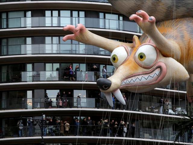 Crowds gather on terraces to see a balloon of Ice Age's Scrat float along West 59th Street during the 90th Macy's Thanksgiving Day Parade in Manhattan on November 24, 2016. (Andrew Kelly/Reuters) Crowds gather on terraces to see a balloon of Ice Age's Scrat float along West 59th Street during the 90th Macy's Thanksgiving Day Parade in Manhattan on November 24, 2016. (Andrew Kelly/Reuters)