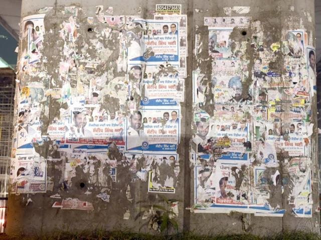 Posters defacing the pillars in Amritsar.(HT Photo)