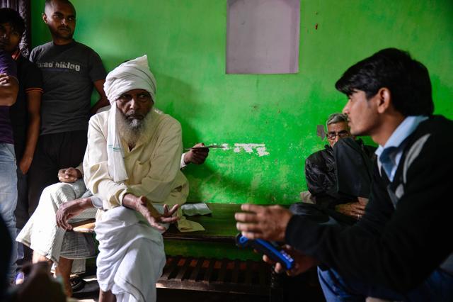 A bank correspondent inputs bank details of villagers on a mobile banking machine in Basendua village in Bulandshahr, in northern Uttar Pradesh state. (AFP) A bank correspondent inputs bank details of villagers on a mobile banking machine in Basendua village in Bulandshahr, in northern Uttar Pradesh state. (AFP)