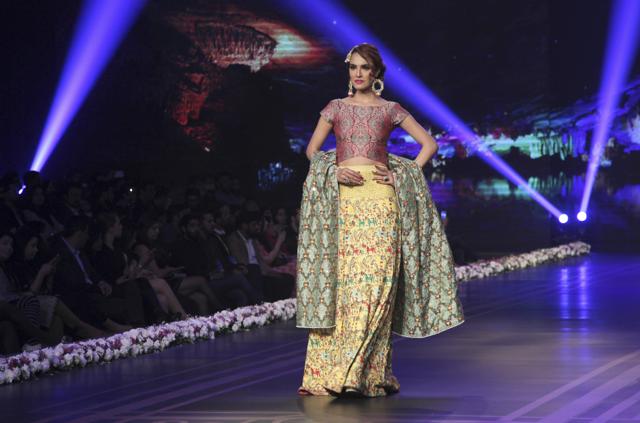 A model presents a bridal creation by designer The House of Arsalan Iqbal during the fashion extravaganza. (AP) A model presents a bridal creation by designer The House of Arsalan Iqbal during the fashion extravaganza. (AP)
