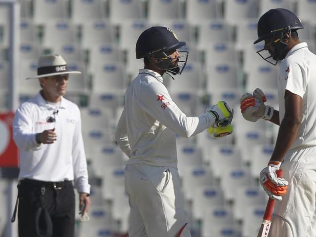 Ravichandran Ashwin (left) and Ravindra Jadeja run between the wickets in the Mohali Test(BCCI)