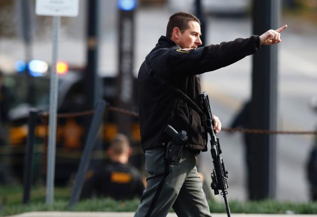 A law enforcement official motions for people to leave the area outside of a parking garage on the campus of Ohio State University as they respond to an active attack in Columbus, Ohio. (AFP) A law enforcement official motions for people to leave the area outside of a parking garage on the campus of Ohio State University as they respond to an active attack in Columbus, Ohio. (AFP)