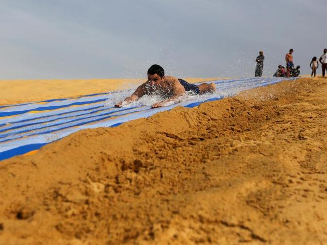 The place is also famous for its extensive mobile sand dunes. A man slides down a ramp leading up to the lake. (REUTERS) The place is also famous for its extensive mobile sand dunes. A man slides down a ramp leading up to the lake. (REUTERS)