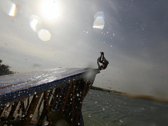 A man slides down a ramp into the lake. (REUTERS) A man slides down a ramp into the lake. (REUTERS)