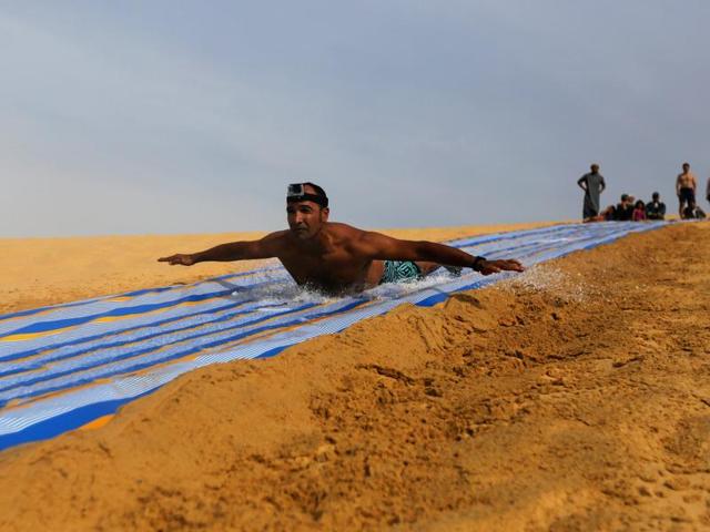 The lakes actually comprise two water bodies -- upper and lower lakes -- with waterfalls between the two. A man slides down a ramp into the lake. (REUTERS) The lakes actually comprise two water bodies -- upper and lower lakes -- with waterfalls between the two. A man slides down a ramp into the lake. (REUTERS)