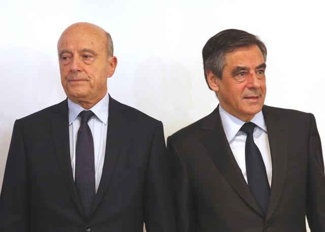 Conservative's party presidential nominee, Francois Fillon, right, and runner-up, Alain Juppe, pose for photographers at the primary's high authority headquarters in Paris on Sunday. (AP Photo) Conservative's party presidential nominee, Francois Fillon, right, and runner-up, Alain Juppe, pose for photographers at the primary's high authority headquarters in Paris on Sunday. (AP Photo)