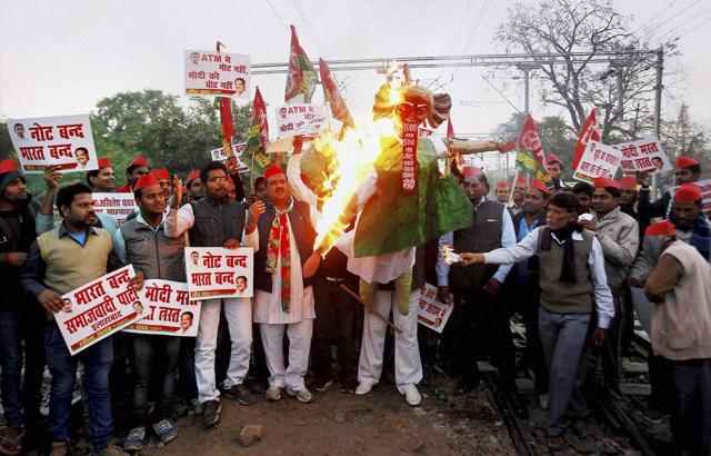 Samajwadi Party workers burn effigy of Prime Minister Narendra Modi near Prayag Railway Station in Allahabad on Monday as part of a nation-wide protest against the demonetisation move . (PTI) Samajwadi Party workers burn effigy of Prime Minister Narendra Modi near Prayag Railway Station in Allahabad on Monday as part of a nation-wide protest against the demonetisation move . (PTI)