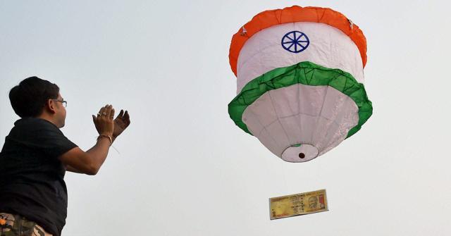 A man releases a hot air balloon attached to a replica of the demonetised Rs 500 note, in Kolkata on Sunday. (PTI) A man releases a hot air balloon attached to a replica of the demonetised Rs 500 note, in Kolkata on Sunday. (PTI)