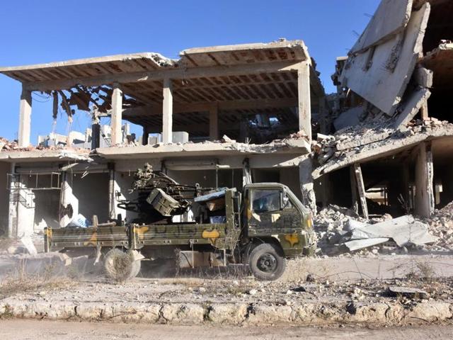 A vehicle of Syrian pro-government forces drives past damaged buildings on November 27 in eastern Aleppo, a day after they reseized it from rebel fighters. (AFP photo) A vehicle of Syrian pro-government forces drives past damaged buildings on November 27 in eastern Aleppo, a day after they reseized it from rebel fighters. (AFP photo)