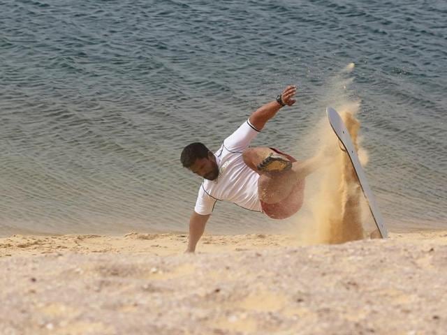 A man falls while sandboarding. (REUTERS) A man falls while sandboarding. (REUTERS)