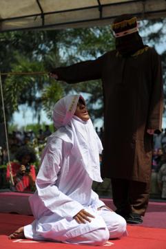 The Acehnese woman cries in pain as she is flogged in Banda Aceh for spending time in close proximity with a man who is not her husband, which is against sharia law. (AFP) The Acehnese woman cries in pain as she is flogged in Banda Aceh for spending time in close proximity with a man who is not her husband, which is against sharia law. (AFP)