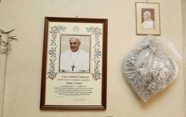 A parchment with papal blessing is hanged on a wall of Emma Morano home, in the day of her birthday, in Verbania, Italy. (AP) A parchment with papal blessing is hanged on a wall of Emma Morano home, in the day of her birthday, in Verbania, Italy. (AP)