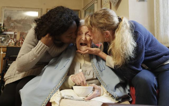 Emma Morano, 117 years hold, is kissed by her caretakers Malgorzat Ceglinska, right, and Yamilec Vergara, in the day of her birthday in Verbania, Italy. (AP) Emma Morano, 117 years hold, is kissed by her caretakers Malgorzat Ceglinska, right, and Yamilec Vergara, in the day of her birthday in Verbania, Italy. (AP)