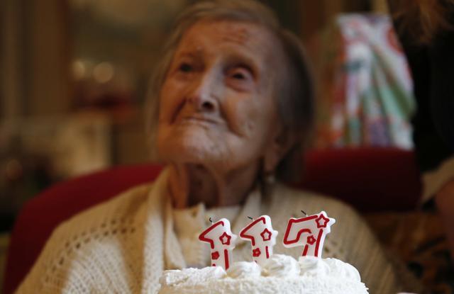 Emma Morano is pictured behind a cake with candles marking 117 years in the day of her birthday in Verbania, Italy. (AP) Emma Morano is pictured behind a cake with candles marking 117 years in the day of her birthday in Verbania, Italy. (AP)