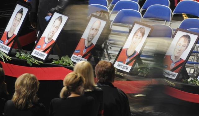 People pass by portraits of victims during a memorial ceremony for those killed in the Russian ice hockey team Lokomotiv Yaroslav plane crash at Arena-2000 the team's stadium in Yaroslavl on September 10, 2011. The Russian city mourning the loss of its ice hockey team in the September 7 plane disaster payed its last respects in the team's home arena. The accident, which killed 43, was the worst sporting disaster in the country's recent memory, claiming the lives of several international players who played in the National Hockey League and previously won Olympic medals. (AFP) People pass by portraits of victims during a memorial ceremony for those killed in the Russian ice hockey team Lokomotiv Yaroslav plane crash at Arena-2000 the team's stadium in Yaroslavl on September 10, 2011. The Russian city mourning the loss of its ice hockey team in the September 7 plane disaster payed its last respects in the team's home arena. The accident, which killed 43, was the worst sporting disaster in the country's recent memory, claiming the lives of several international players who played in the National Hockey League and previously won Olympic medals. (AFP)