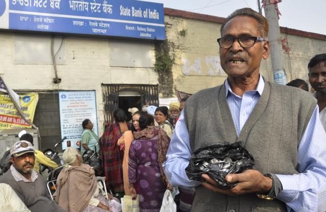 A man who was given two-rupee coins of Rs 100 by a bank in Jalandhar on Thursday. (Sikander Singh Chopra/HT)