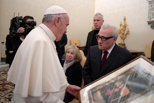 Pope Francis looks at a painting given to him as a gift from director Martin Scorsese, right, on the occasion of their private audience at the Vatican, Wednesday, Nov. 30, 2016. (AP)