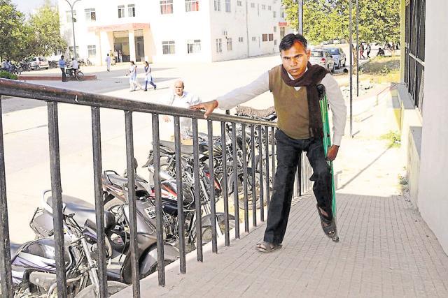Kesri Lal Bairwa walking on a newly constructed disabled-friendly ramp and railing at Atal Sewa Kendr in Jhalawar. (AH Zaidi/ HT Photo)