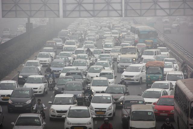 Vehicles move slowly along a stretch of road in Gurugram on Friday. (PTI) Vehicles move slowly along a stretch of road in Gurugram on Friday. (PTI)