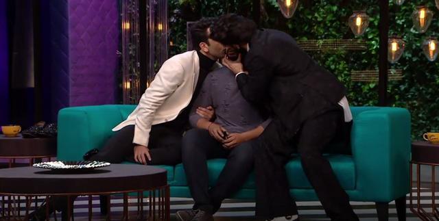 Ranbir Kapoor (L), Ranvir Singh (R) and Arjun Kapoor (C) acing the recently-introduced ‘Kiss with Them’ segment on Karan Johar’s Koffee couch. (Screen grab)