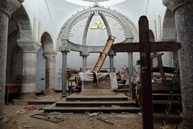 Debris litter the ground of the heavily damaged Saint John the Baptist church in the Christian town of Qaraqosh, also know as Hamdaniya. (AFP Photo) Debris litter the ground of the heavily damaged Saint John the Baptist church in the Christian town of Qaraqosh, also know as Hamdaniya. (AFP Photo)