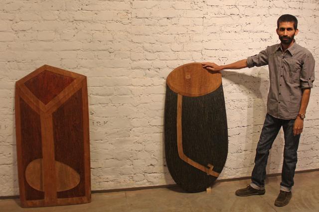 Artist Bhuvanesh Gowda with the artwork called relief works in wood . (Bhushan Koyande) Artist Bhuvanesh Gowda with the artwork called relief works in wood . (Bhushan Koyande)