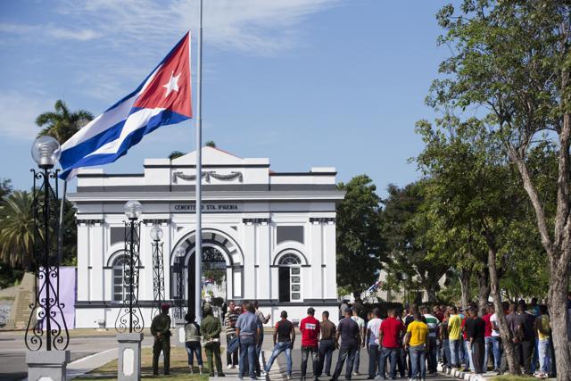People stand at the entrance of the Santa Ifigenia cemetery where the ashes of Fidel Castro were interred in Santiago. (AP Photo) People stand at the entrance of the Santa Ifigenia cemetery where the ashes of Fidel Castro were interred in Santiago. (AP Photo)