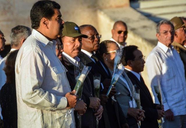 Venezuela's President Nicolas Maduro, left, and Nicaragua's President Daniel Ortega attend the burial ceremony of the ashes of the late Fidel Castro at the Santa Ifigenia cemetery in Santiago. (AP Photo) Venezuela's President Nicolas Maduro, left, and Nicaragua's President Daniel Ortega attend the burial ceremony of the ashes of the late Fidel Castro at the Santa Ifigenia cemetery in Santiago. (AP Photo)