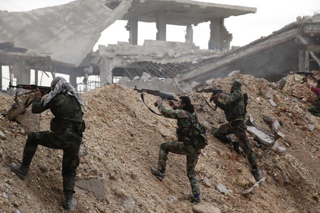 Syrian army soldiers fire their weapons during a battle with rebel fighters at the Ramouseh front line, east of Aleppo. (AP Photo) Syrian army soldiers fire their weapons during a battle with rebel fighters at the Ramouseh front line, east of Aleppo. (AP Photo)