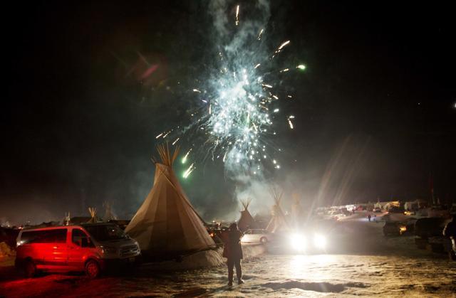 Fireworks go off over the Oceti Sakowin camp where people have gathered to protest the Dakota Access oil pipeline in Cannon Ball, N.D., Sunday, Dec. 4, 2016. US Army Corps of Engineers spokeswoman Moria Kelley said in a news release Sunday that the administration will not allow the four-state, $3.8 billion pipeline to be built under Lake Oahe, a Missouri River reservoir where construction had been on hold. (AP Photo) Fireworks go off over the Oceti Sakowin camp where people have gathered to protest the Dakota Access oil pipeline in Cannon Ball, N.D., Sunday, Dec. 4, 2016. US Army Corps of Engineers spokeswoman Moria Kelley said in a news release Sunday that the administration will not allow the four-state, $3.8 billion pipeline to be built under Lake Oahe, a Missouri River reservoir where construction had been on hold. (AP Photo)