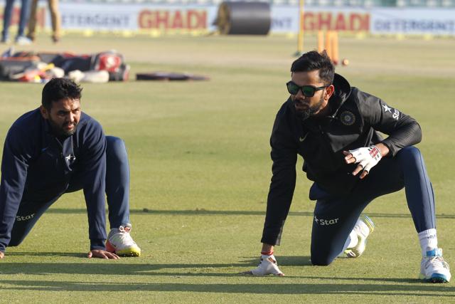 Virat Kohli and Parthiv Patel warm up for the third India vs England Test in Mohali . (BCCI )