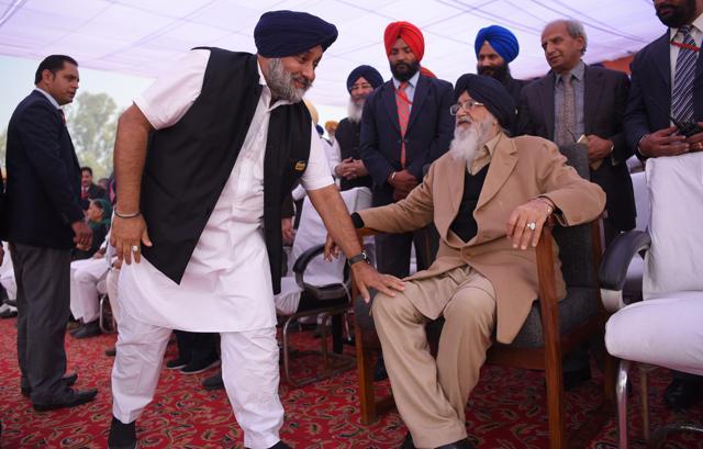 His son and deputy Sukhbir Badal takes blessings of CM Parkash Singh Badal at the rally stage. (HT Photo)