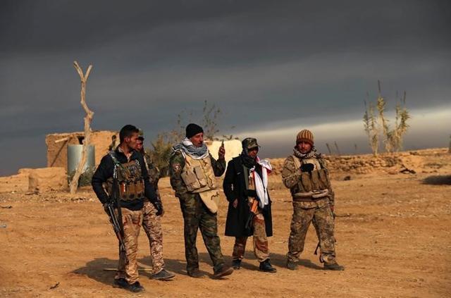 Jubbouri talks to Iraqi soldiers during their fight against Islamic State militants (Reuters )