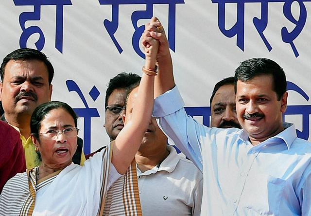 Delhi Chief Minister Arvind Kejriwal and West Bengal Chief Minister Mamata Banerjee join hands at mass rally against demonetisation of currency notes, at Azadpur Mandi in New Delhi . (PTI) Delhi Chief Minister Arvind Kejriwal and West Bengal Chief Minister Mamata Banerjee join hands at mass rally against demonetisation of currency notes, at Azadpur Mandi in New Delhi . (PTI)