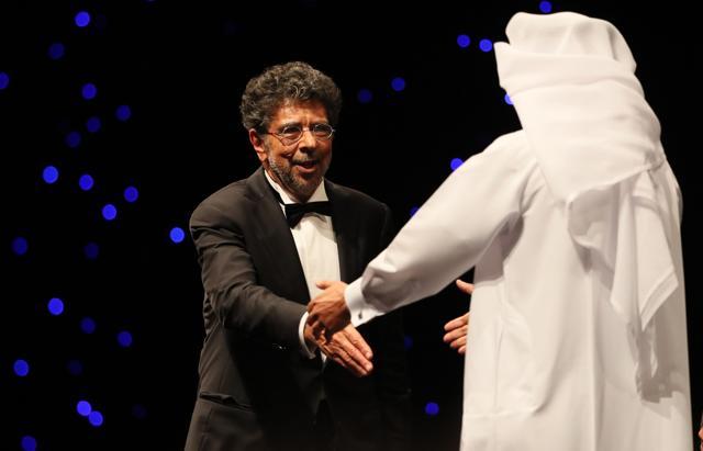 Lebanese-French composer Gabriel Yared (L) receives the Lifetime Achievement award at the 13th Dubai International Film Festival (DIFF) on December 7, 2016. (AFP)