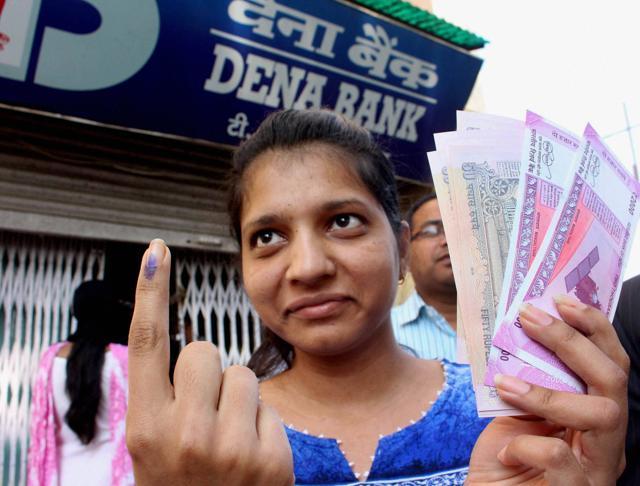 A young girl shows her inked marked finger after exchanging her old currency from a bank in Bhopal . (PTI) A young girl shows her inked marked finger after exchanging her old currency from a bank in Bhopal . (PTI)